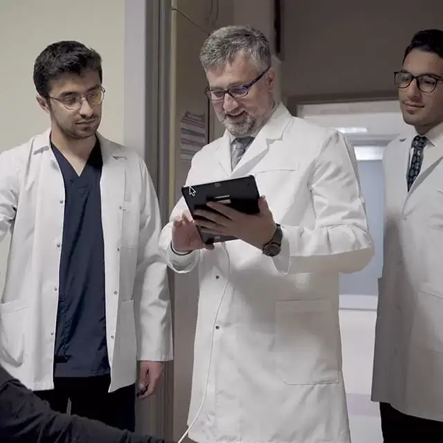 Prof. Dr. Kocabicak reviewing patient data with medical team